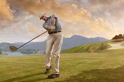 Man Swinged Golf Ball in Sunset